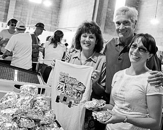 FAMILY AFFAIR: Linda Glenn, Pastor Frank Glenn and daughter Beth Glenn check out some of the offerings at the 13th Annual Glenn Christian Foundation and Church's Ox Roast car show at the Trumbull County Fairground.