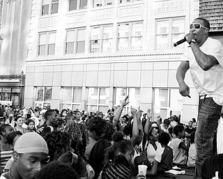 Keyland "100 Proof" Logan, 27, of Youngstown raps for the crowd at the Lucky Penny Family Reunion in downtown Youngstown.
