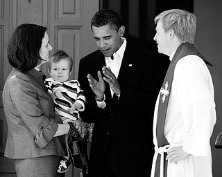 AFTER CHURCH: Democratic presidential candidate Sen. Barack Obama of Illinois, center, talks with Pastor Lars Olson and his wife, Pastor Katherine Olson, and son, carl Olson, 11 months, after going to church at St. Luke's Lutheran Church in Lima, Ohio. Obama attended a service there Sunday.