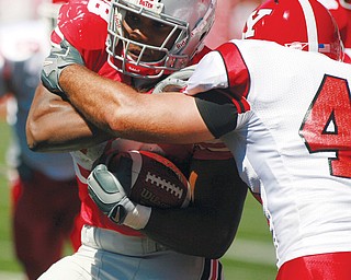 PRE-INJURY: Ohio State tailback Chris "Beanie" Wells, left, is tied up by Youngstown State defender Mike Barlak during Saturday's game at Ohio Stadium in Columbus.