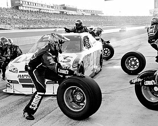 FAST STOP: Jimmie Johnson's pit crew tends to his car during the NASCAR Sprint Cup Series' Pepsi 500 Sunday at Auto Club Speedway in Fonatana, Calif.