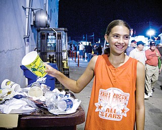 HEAPING: Megan Sefehik, 12, of Austintown, drops off garbage into one of the many receptacles around the Canfield Fair.