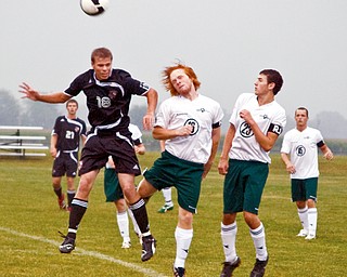 CARDINALS AIM FOR TOURNAMENT SUCCESS: Canfield's Dominic Mirto (18) outjumps a West Branch defender for the ball during a game last week. The Cardinals made it to the district tournament last year and have their sights eset on another district championship.