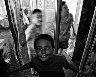 Randy Rogensky, 11, of Hubbard beats his friend out of the maze of mirrors. Daniel C. Britt.