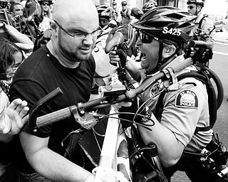 CLASH: St. Paul, Minn., police officers push back protesters using a large sign during an anti-war demonstration at the Republican National Convention. The clash took place Monday.