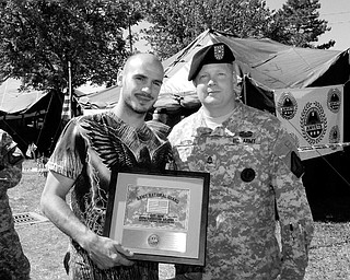MILITARY SUPPORT: MILITARY SUPPORT: Middleweight Champion Kelly Pavlik accepts an Appreciation Award from Sgt. 1st Class Mark Hutton of the Army National Guard in recognition of Pavlik's support of the military. Pavlik wore boxing trunks featuring an American flag with the insignias of the five branches of the military for his June bout with Gary Lockett.