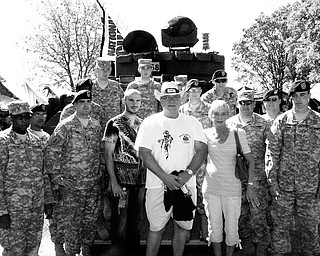 MILITARY SUPPORT: Middleweight Champion Kelly Pavlik and his parents, Mike and Debbie Pavlik, pose with members of the 583rd Law and Order Detachment and the 838th Military Police Company, both based out of Austintown. The troop members served in Iraq. Pavlik wore boxing trunks featuring an American flag with the insignias of the five branches of the military for his June bout with Gary Lockett.
