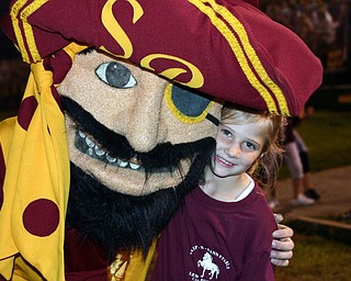 "Little Raider fan Elizabeth Cortwright gets a hug from the South Range mascot."