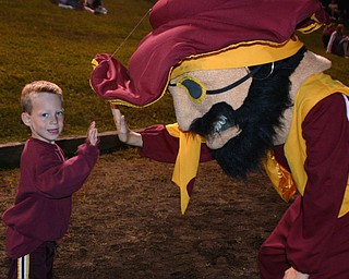 "Raider fan Ezra Stewart high fives the South Range Mascot."
