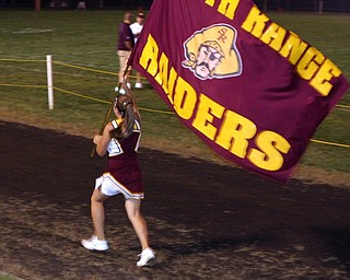 "Varsity Cheerleader, Brittany Haynes, runs the South Range flag after a score."