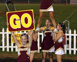 "South Range Varsity cheerleader,Jordan Stear, encourages the crowd to
yell GO, while stunters Danielle Pendice, Brittany Haynes, Jesse Heck
and Courtney Driscoll encourage the crowd from higher up!"