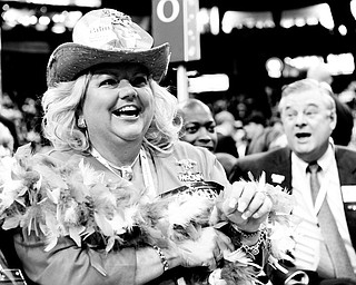 HAVING A GOOD TIME: Alternate Ohio delegate Kathy Eshelman of Dublin, Ohio, reacts to the speeches with others during the Republican National Convention in St. Paul, Minn. She was appropriately attired in political regalia for the event Wednesday.