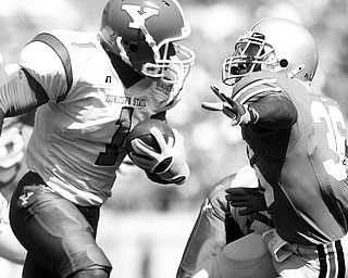 TRYING FOR A GAIN: Youngstown State's Ferlando Williams (1) tries to put a move on Ohio State's Austin Spitler during last Saturday's game in Columbus.