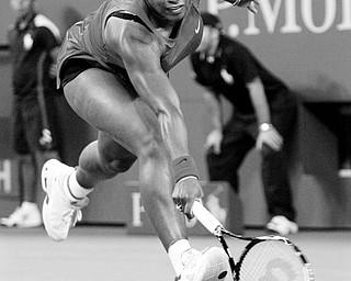 SISTERS IN TENNIS: Serena Williams attempts to return a shot from her sister Venus during their quarterfinal match at the U.S. Open in New York Wednesday. Serena won the match 7-6 (8), 7-6.