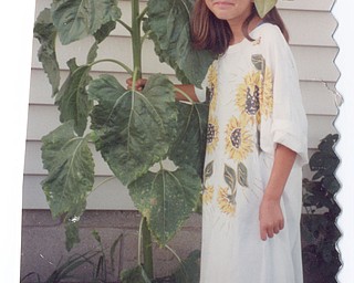 SCRAPBOOK FIND: Patty Gordulic of Canfield found a giant sunflower in her yard. Since she never grew anything before, she was quite shocked. It appears a bird dropped the seed from her feeder. Her niece, Brianna Gordulic, agreed to pose with the sunflower with a sunflower shirt.