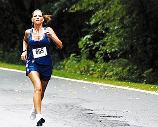 TUNED IN: Diane Villanueva of the Anthem team competes in the 10K relay at Mill Creek Park. The YOungstown Community Cup compeition concluded Saturday.