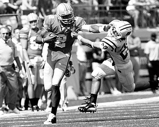 STIFF TEST: OSU quarterback Terrelle Pryor (2) stiff arms Ohio defender Donte Harden (28) during the fourth quarter of Saturday's game.