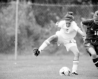 HANDS OFF: Mooney's Kelcie Herberger, left, tries to keep the ball from Walsh Jesuit's Elizabeth Bollinger during Saturday's game in Struthers.
