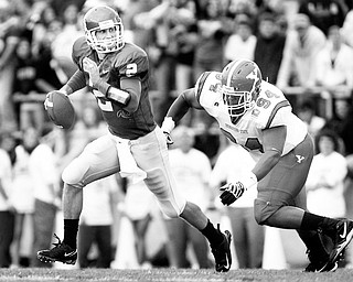 SACK ATTACK: Youngstown State defensive tackle Torrance Nicholson (94) closes in on South Dakota State quarterback Ryan Berry during Saturday's game.