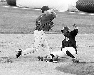 SLIDING IN: Scrappers baserunner Isaias Velasquez tries to break up the double play as Auburn's Bryan Kevin makes the throw to first Saturday night at Eastwood Field.