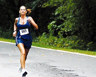 TUNED IN: Diane Villanueva of the Anthem team competes in the 10K relay at Mill Creek Park Saturday. The Youngstown Community Cup concluded Saturday.