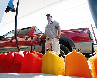 IKE PREPARATION: Sean Eitneiser fills his truck and gas cans with fuel at a station in Islamorada, Fla. Officials in teh Florida Keys started a phased evacuation for residents Sunday morning after telling visitors a day earlier to get out. Hurricane Ike was forecast to affect the Keys sometime this week.