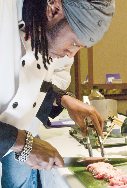 Ray Lewis of the Tapazza restaurant in Boardman slices up seared tuna.