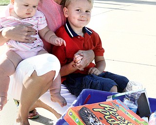 FAMILY VALUES: The Flament family, from left, Alyssa, 9 months; Sarah; and Logan, 4, display a bin of recyclables outside their home in Poland. The family is taking a more environmentally friendly approach to daily living.