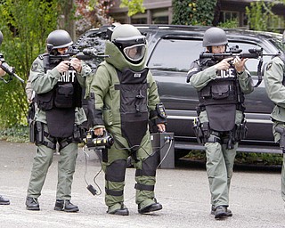 SWAT Team members surround bomb squad officers as part of a disaster drill coordinated by Mahoning County Emergency Management Agency.