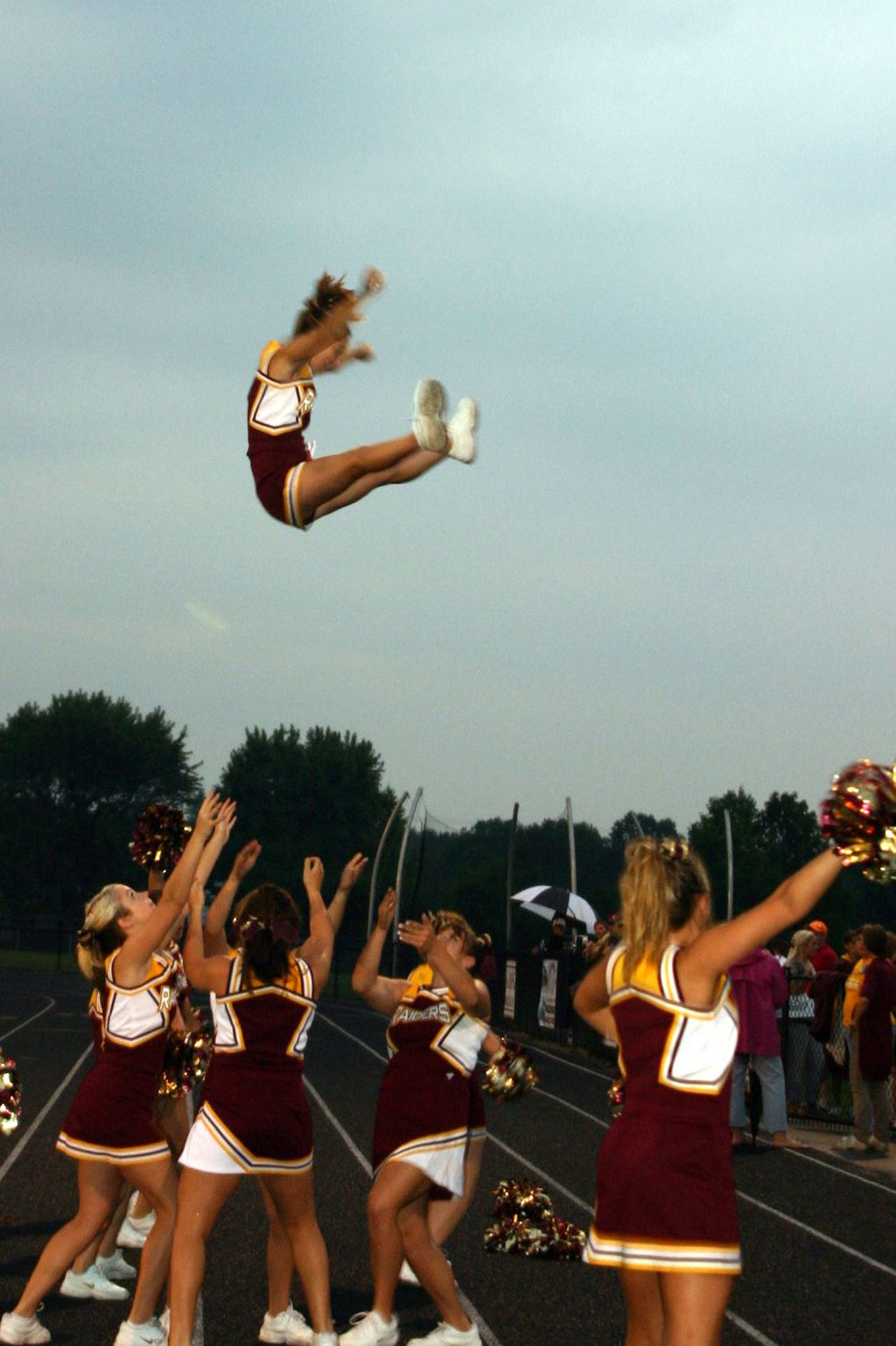 "Whitney Gould is caught by her fellow South Range cheerleaders
Christina Oddo, Rachel Kelly, Melissa Williams, and Julianne Dundee.