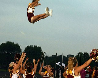 "Whitney Gould is caught by her fellow South Range cheerleaders
Christina Oddo, Rachel Kelly, Melissa Williams, and Julianne Dundee.