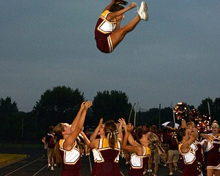 "South Range cheerleader, Danielle Pendice, flies high with the help
of fellow cheerleaders Brittany Haynes, Jesse Heck, and Courtney
Driscoll.