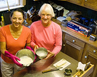 SHARED EXPERIENCE: Linda Hoefert of Youngstown, left, was taught how to make mozzarella cheese with pesto and prosciutto by Sara Scudier in Scudier's Youngstown home. Scudler belongs to the TimeBank Mahoning Valley, a "bank" that takes alternative currency in the form of good deeds tracked by time spent. Scudier deposited an hour by teaching Hoefert.