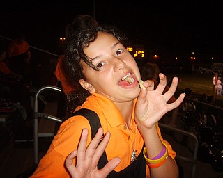 Tiffany Tatar of the Springfield Local Marching Band enjoys some of Lowellvile's concessions after the half time show.