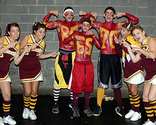 "South Range Varsity cheerleaders point out athletes supporting the
football team. Basketball player Joe Milan and wrestlers Jared Miller
and Beau Bowden painted their jersys on and are cheering the team onto
victory against Sprinfield."