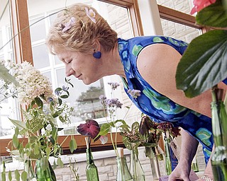 IT'S THE AROMA: Judy Nelson of Columbiana enjoys the smell of a flower at the Garden Forum flower, plant and vegetable show at Mill Creek MetroPark's Fellows Riverside Gardens on Sunday. Nelson said she just happened to stop by the show on a whim.