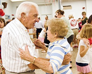 CUTTING A RUG: Bernie and Helen Jakobowski of Canfield show the Youngstown set how it's done as they dance at the Polish Day party at St. Casimir Roman Catholic Church in Youngstown. The event was hosted by the Yougnstown Polish community Sunday. Several hundred people turned out.