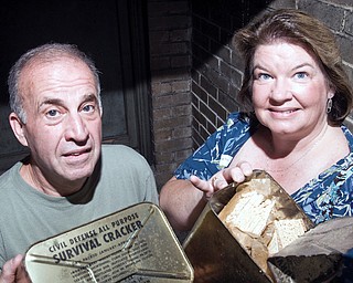 COLD WAR FIND: Paul and Kirsten Lewis of Hubbard discovered cases of saltine cracker rations tucked away in the basement of the Burt Building on West Federal Street in Youngstown during a tour of the structure Sunday. The packaging indicated the crackers have been there since 1963. The commercial/retail building is being converted into a Mahoning Valley History Center.