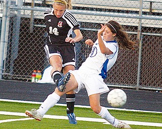 RIVALS: Meredith Gleichert (14) of Canfield and Tatum Marucci of Poland battle for the ball during a recent game.