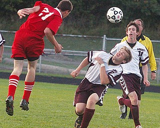 LIBERTY - LABRAE - (21) Jacob Jaros and (8) Pat McGarry play the ball as (11) Eric Wolf looks on during their game Wednesday night at Liberty.
