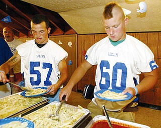 CHOW TIME: Jackson- Milton High School football players Jarrod Shook, left, and Nick Yochman load up on pasta at a team dinner at Wrangler&#8217;s Olde Country Restaurant in North Jackson.