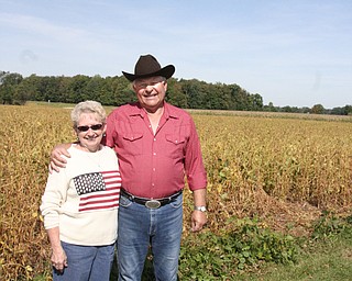 Linda and Henry Lipps stand next to where a GMA truck backed into their soybean field. Behind them by the trees is the railroad track where GMA officials unloaded to meet Linda and Henry.