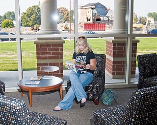 Corrie Romesburg, 17, a Senior at the new high school this year waits for her mother to finish a tour in the new library which boasts new furniture, a computer lab and for limited time, a view of the old building.
