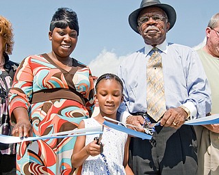 Cutting the ribbon on MLK elementary are, L-R, Cathy Dorbish, Taazmayis Briggs and her daughter Paris Marks, 6, both of Youngstown, Loch Beachum and Youngstown BOE member Mike Murphy.