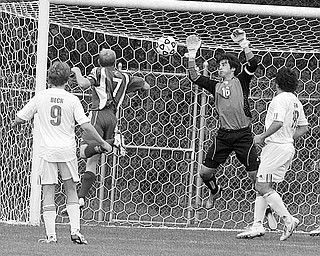 BEATING BAY WILLAGE: Bay Village High soccer player Kyle Hyland is stopped by Mooney goalkeeper Jonathan Critell Saturday in Struthers. Looking on are Mooney's Thomas Beck (9) and RObby Fox.