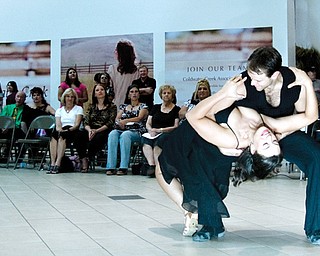 LORD OF THE DANCE: Lauren Gallo of Boardman tangos with Dustin Jones of Fred Astaire School of Dance in Boardman. Jones performed 14 dances in the mall concourse Saturday.