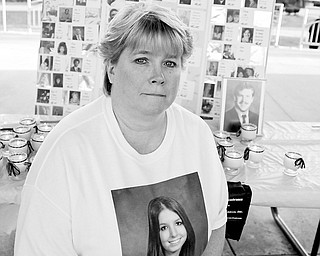 NEVER FORGET: Kathy Migliozzi of Warren lighted a candle for her slain daughter Courtney Rushwin.