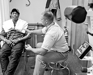 THERAPEUTIC: Youngstown veteran Robino D. Lawrence, left, works with Matt Creed in the physical therapy department of the Veterans Affairs clinic in Youngstown.