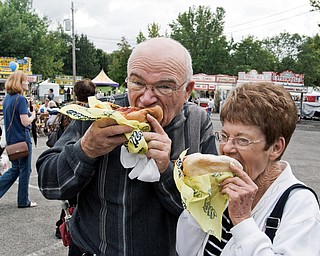 WHAT A BRAT: It’s not Oktoberfest without fresh bratwurst. Jerry Compton and Peggy Ault, both of Boardman, couldn’t resist savoring the traditional sausage meal, complete with onions on top.