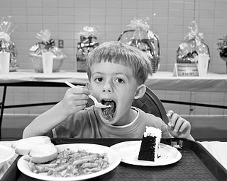 TASTY: Corey Cook, 4, of Boardman filled his plates with spaghetti and cake for a fundraiser by the Mahoning Valley 9/11 Memorial Committee. The Cook family’s contributions on Sunday will go toward a memorial for victims of the Sept. 11, 2001, terrorist attacks.